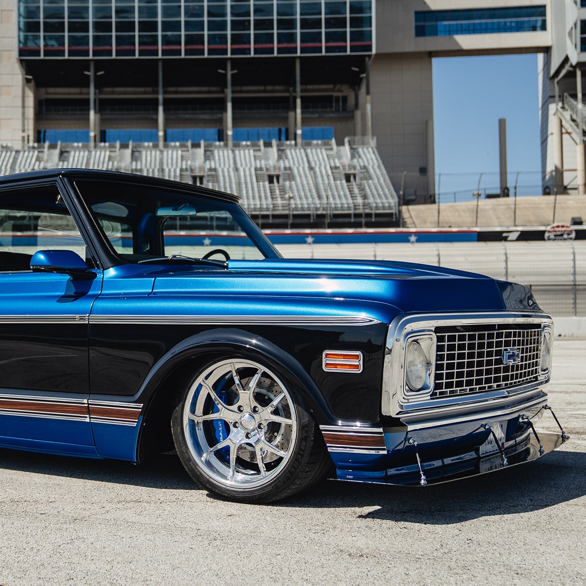 Side View of a Blue Classic Chevrolet Pickup Parked on a Racetrack