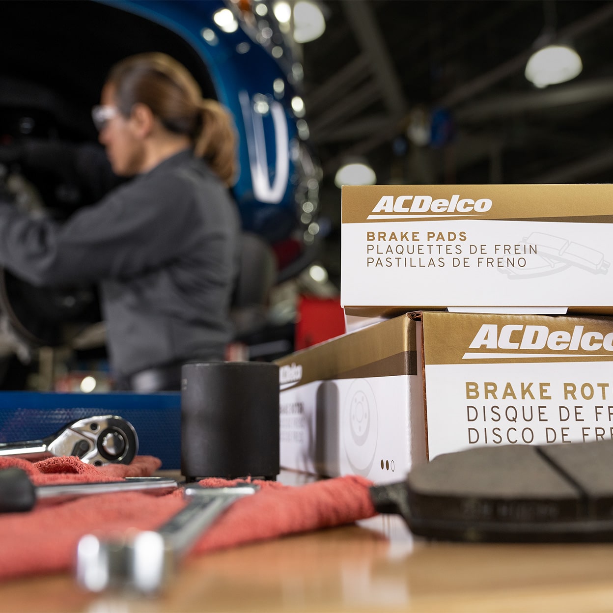Service Advisor Working on Vehicle with ACDelco Products on Table