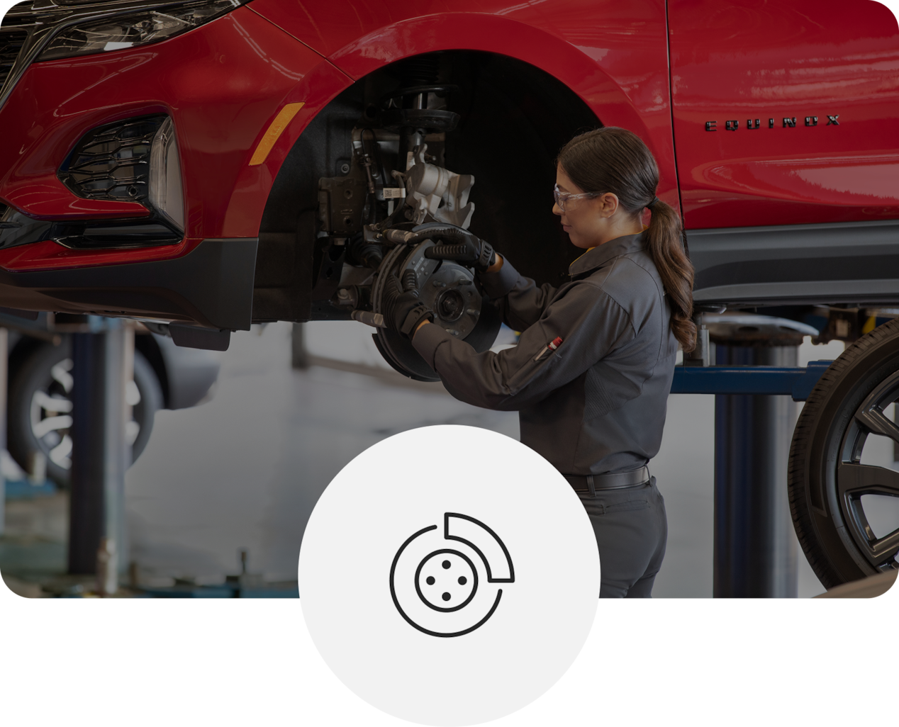 Service Technician Working on Raised Red Vehicle