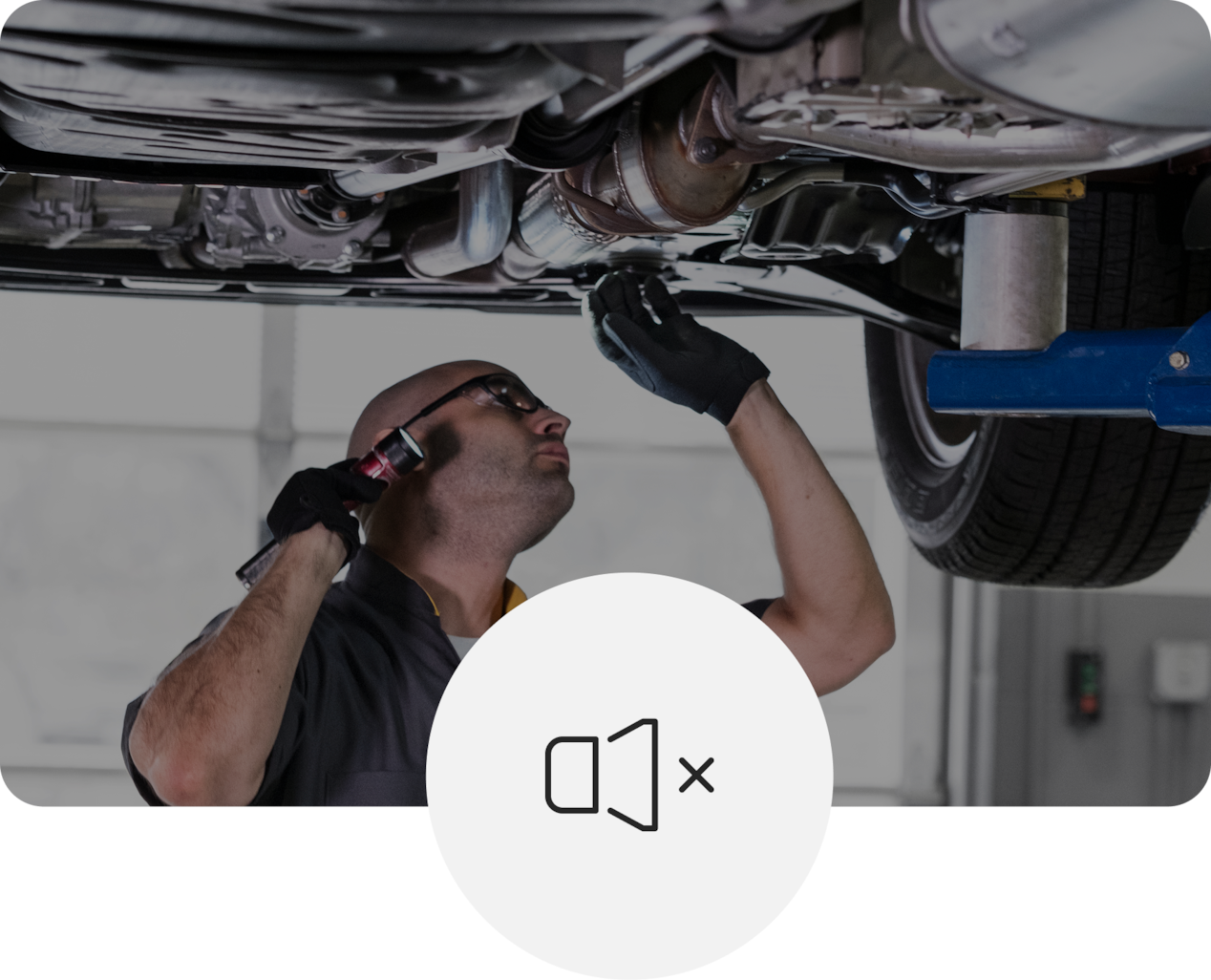 Technician Working Underneath Raised Vehicle