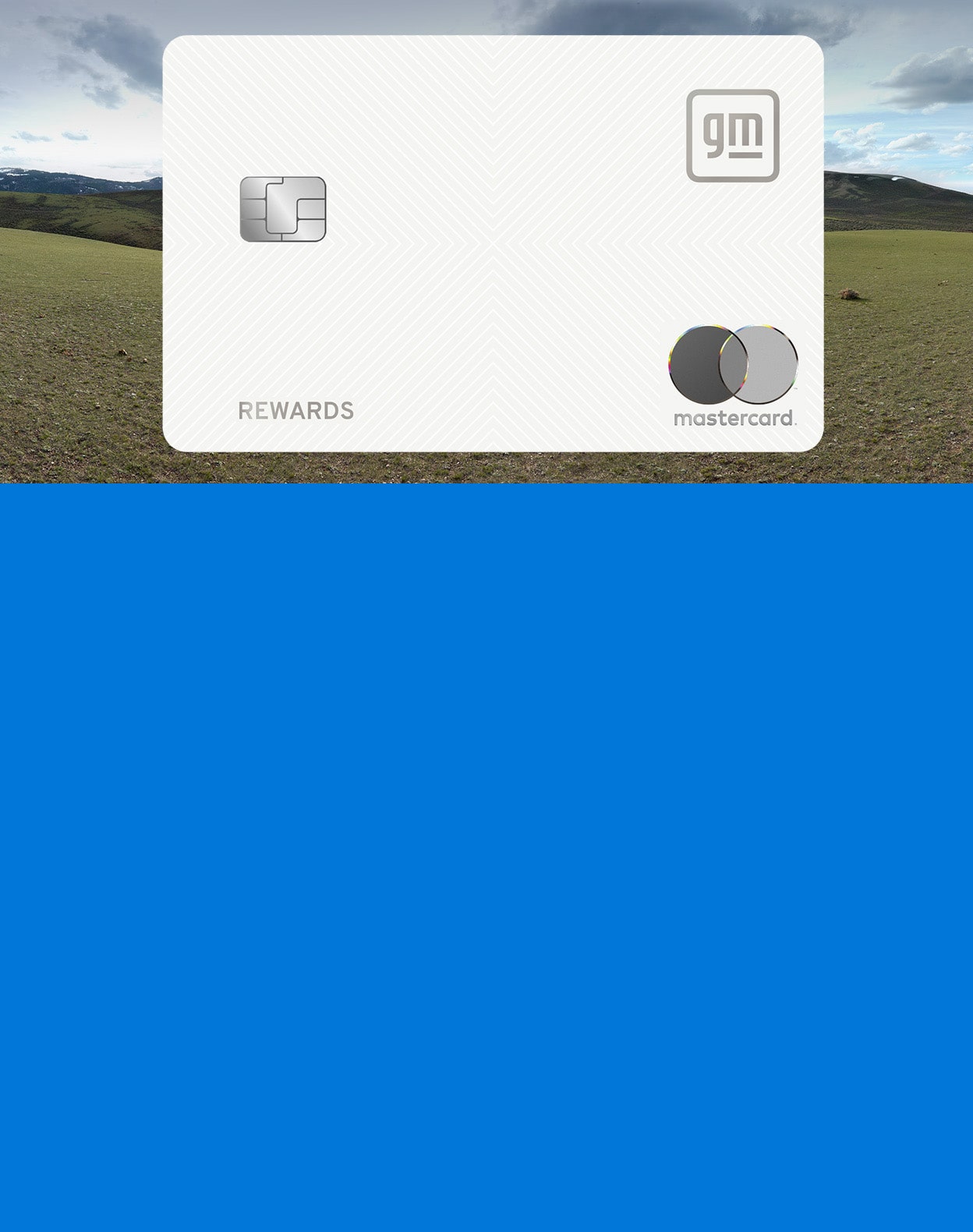 Wide Landscape View of Open Grassy Field Beneath Cloudy Sky with Close-Up of GM Rewards Mastercard and Blue Rectangle