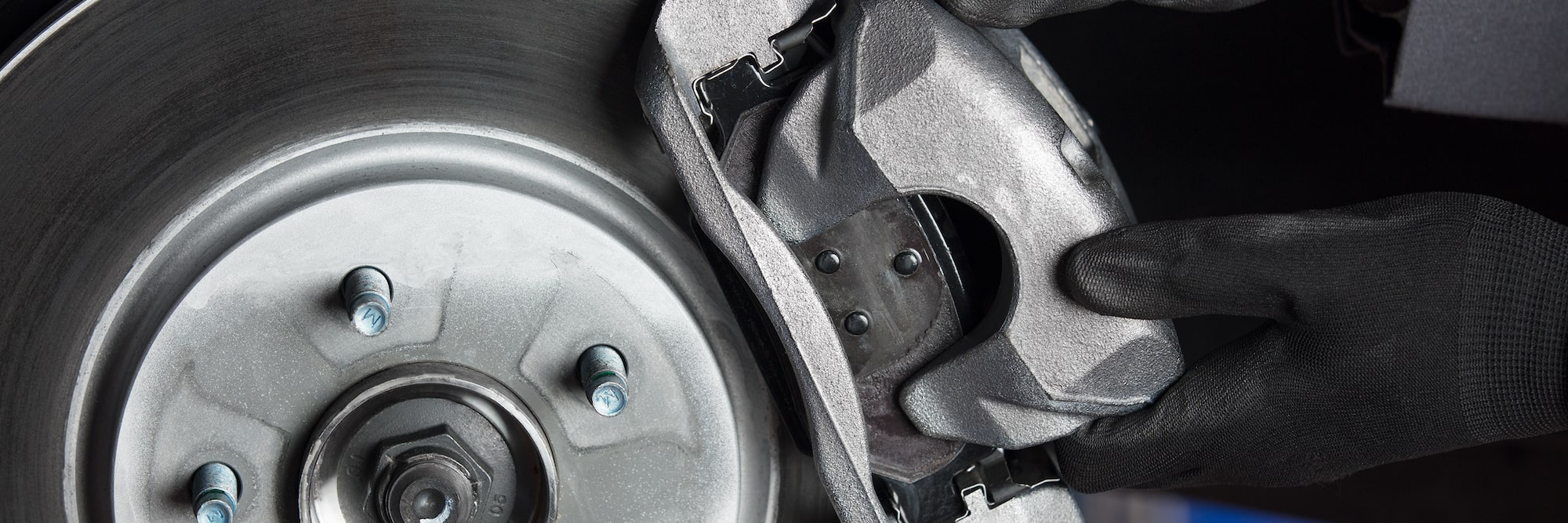 Certified Service technician inspecting the brakes on a Chevrolet at Roseville Chevrolet