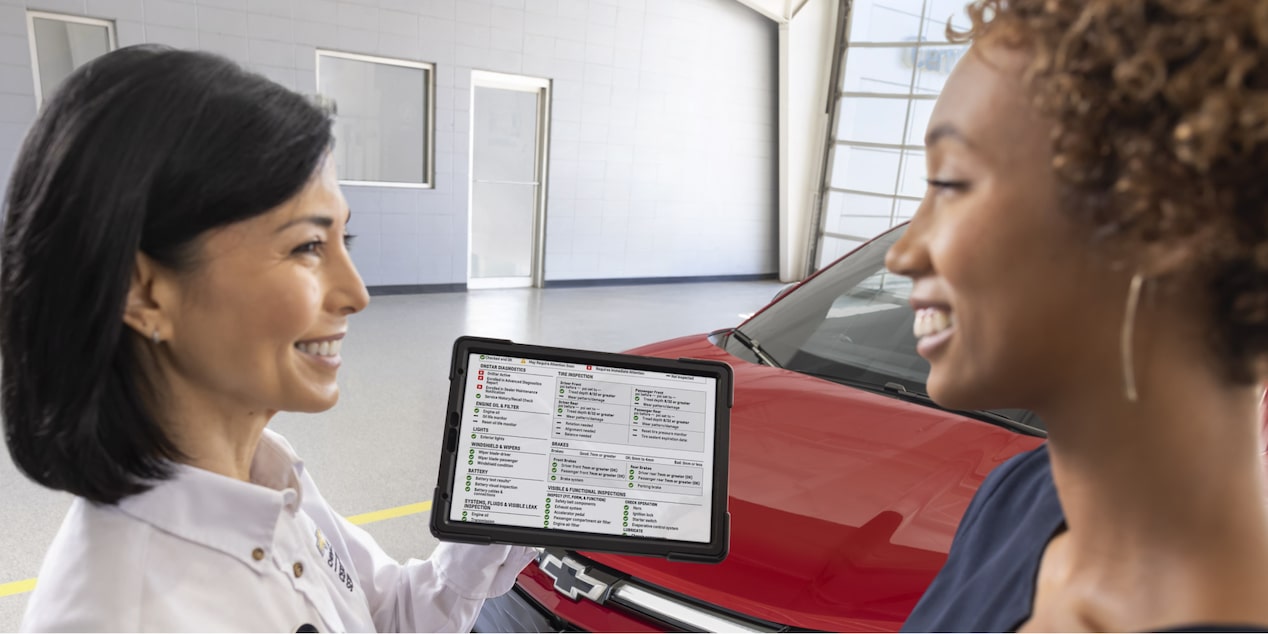 Chevrolet technician showing the service report of their vehicle