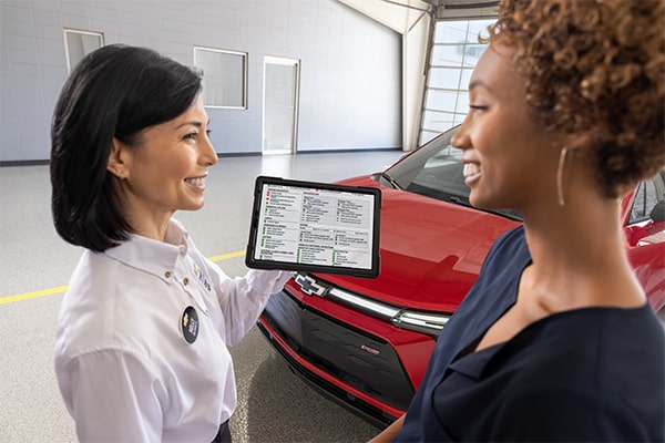 Roseville Chevrolet service advisor going over a vehicle with a customer at drop-off