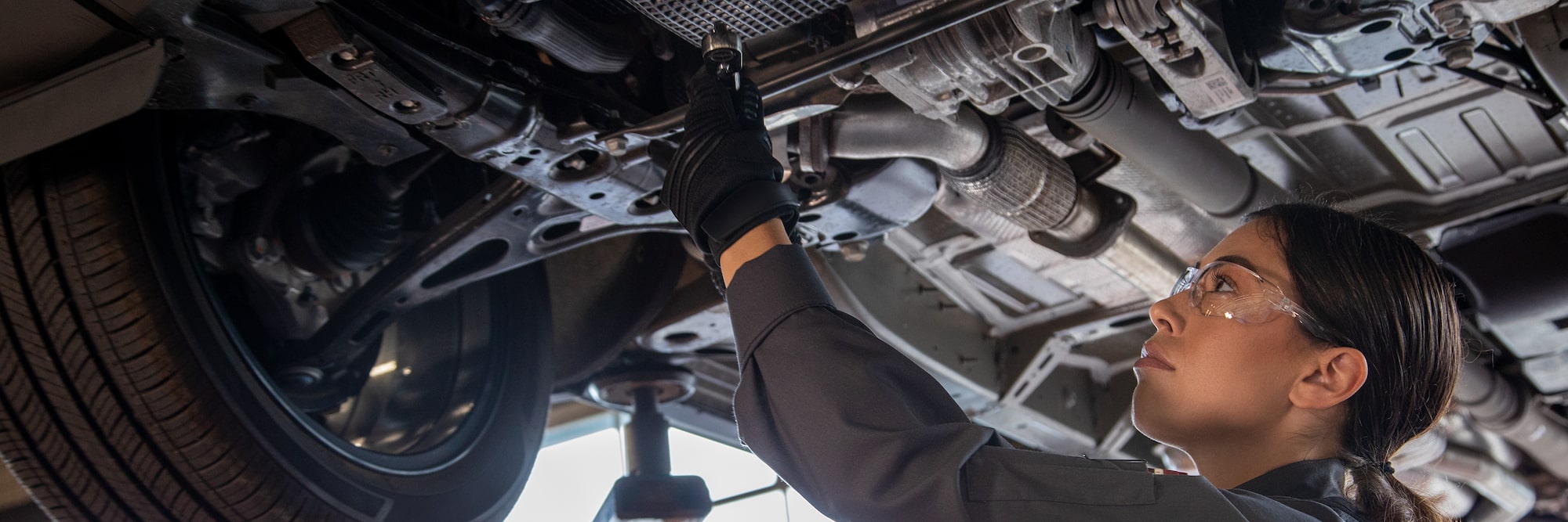 Certified Service technician performing a Chevy oil change at Roseville Chevrolet
