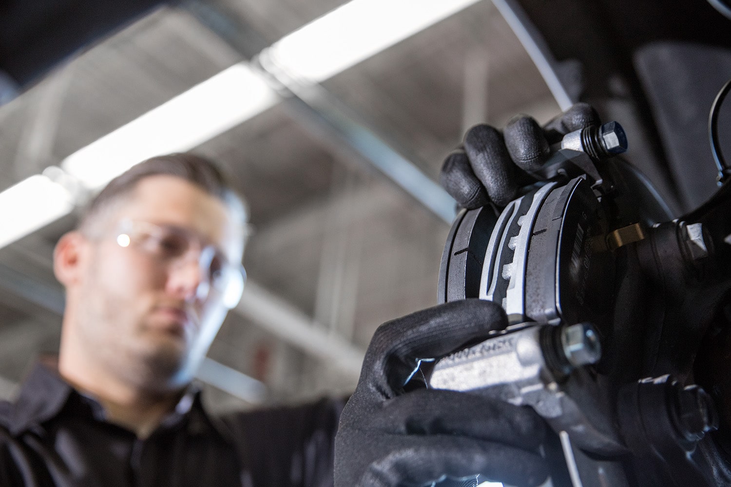 Two Green and White Chevrolet Vehicles on a Plain with Trees and Mountains Peaking from Behind