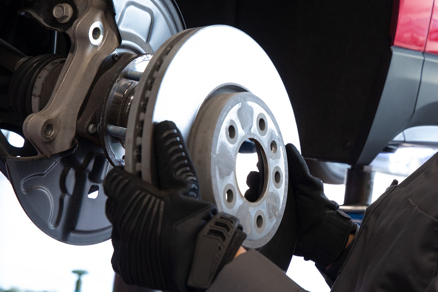 Two Green and White Chevrolet Vehicles on a Plain with Trees and Mountains Peaking from Behind