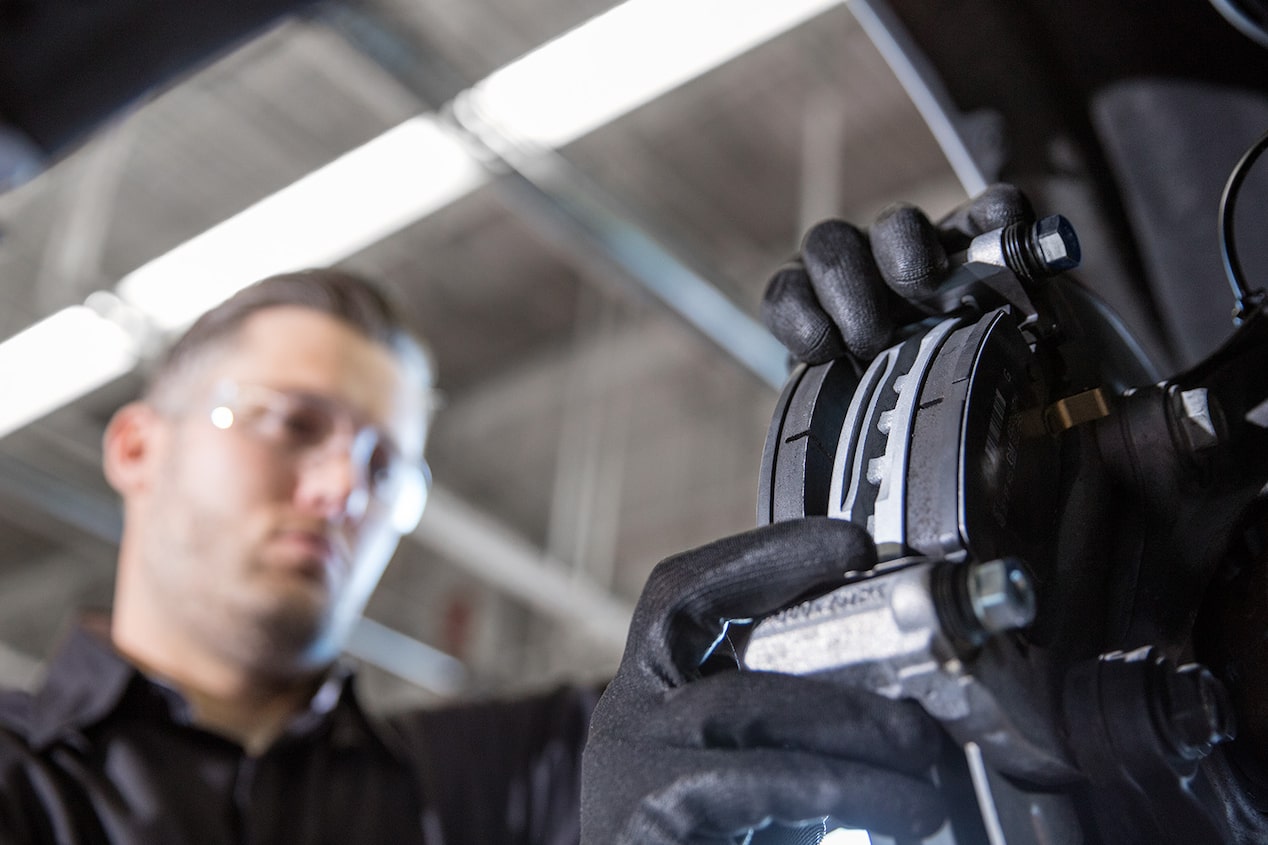 A Mechanic Is Working on the Wheel of a Chevrolet Vehicle