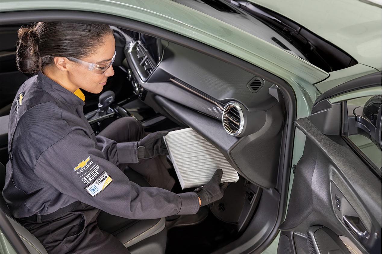 A Mechanic Is Changing the Filter of the Front Passenger Space