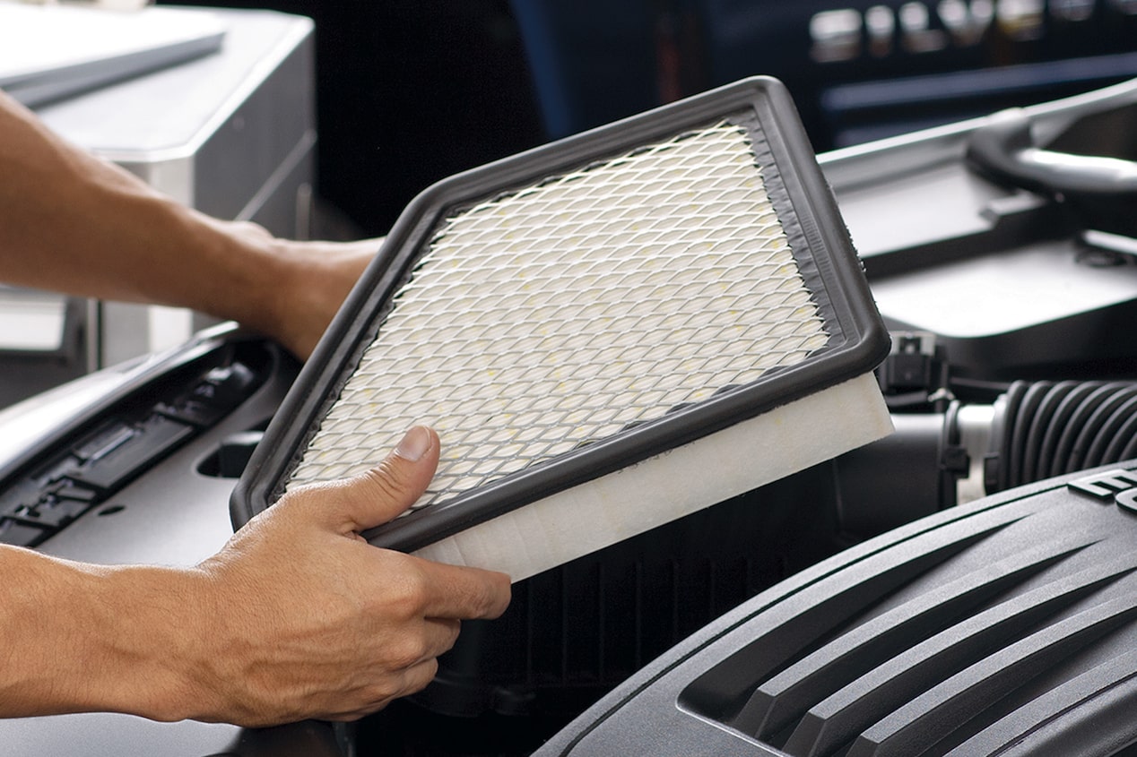 Someone Is Holding a White Air Filter Ready to Place It in a Vehicle