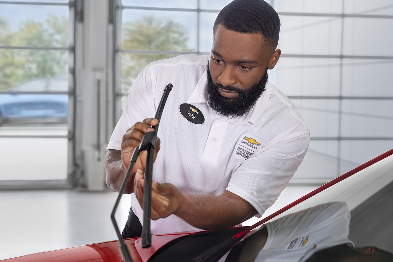 A Mechanic Is Fixing a Windshield Wiper on a Chevrolet Vehicle