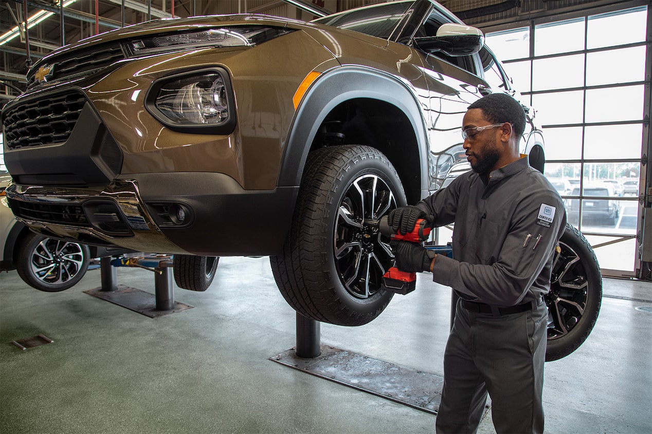 Tire Fresh Start Event Next to Buy 3 Get 1 for $1 on Select Tires Offer Above a Man Working on  a Tire