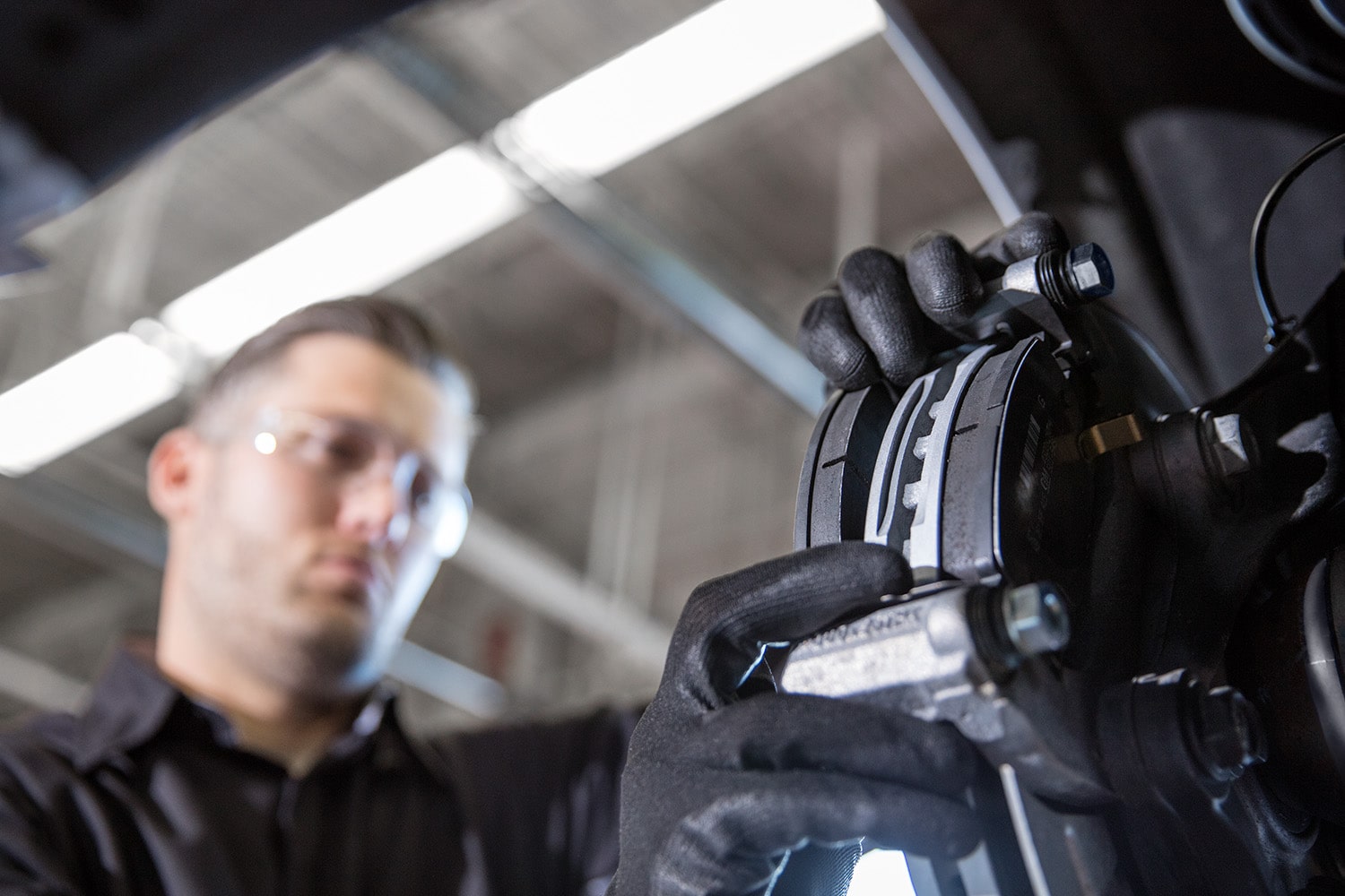 Two Green and White Chevrolet Vehicles on a Plain with Trees and Mountains Peaking from Behind