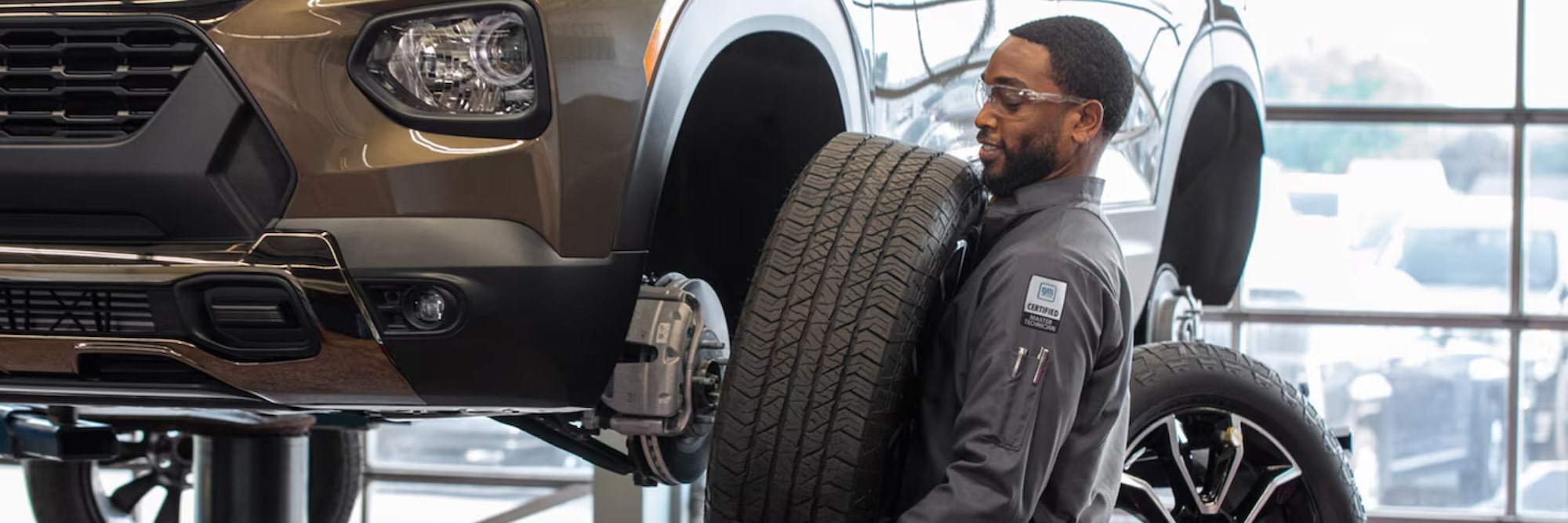Certified Service technician fitting a tire to a Chevrolet at Roseville Chevrolet