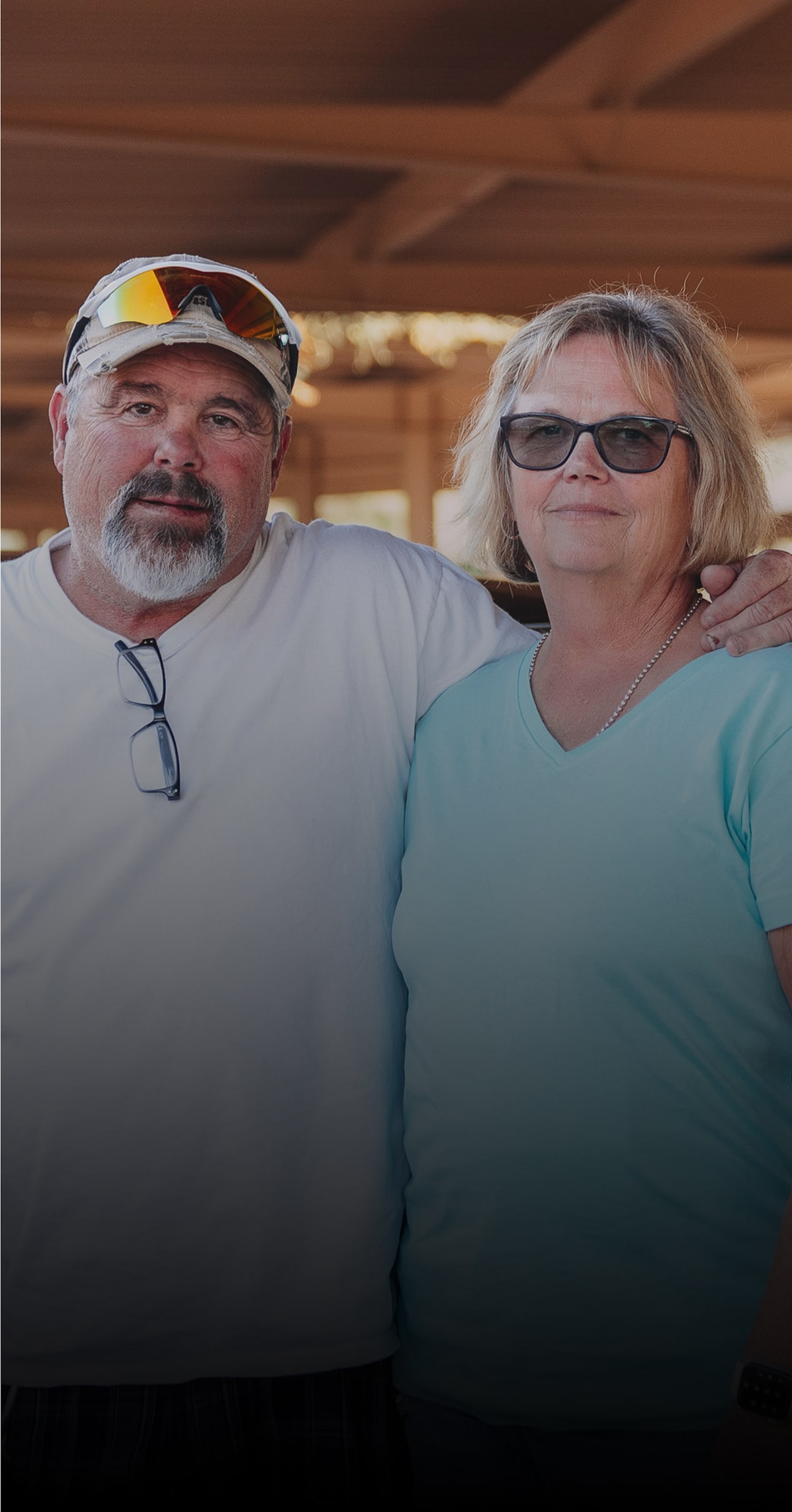 Louie and Laurie Fesmire Posing in Front of a Chevy Car with an Open Hood