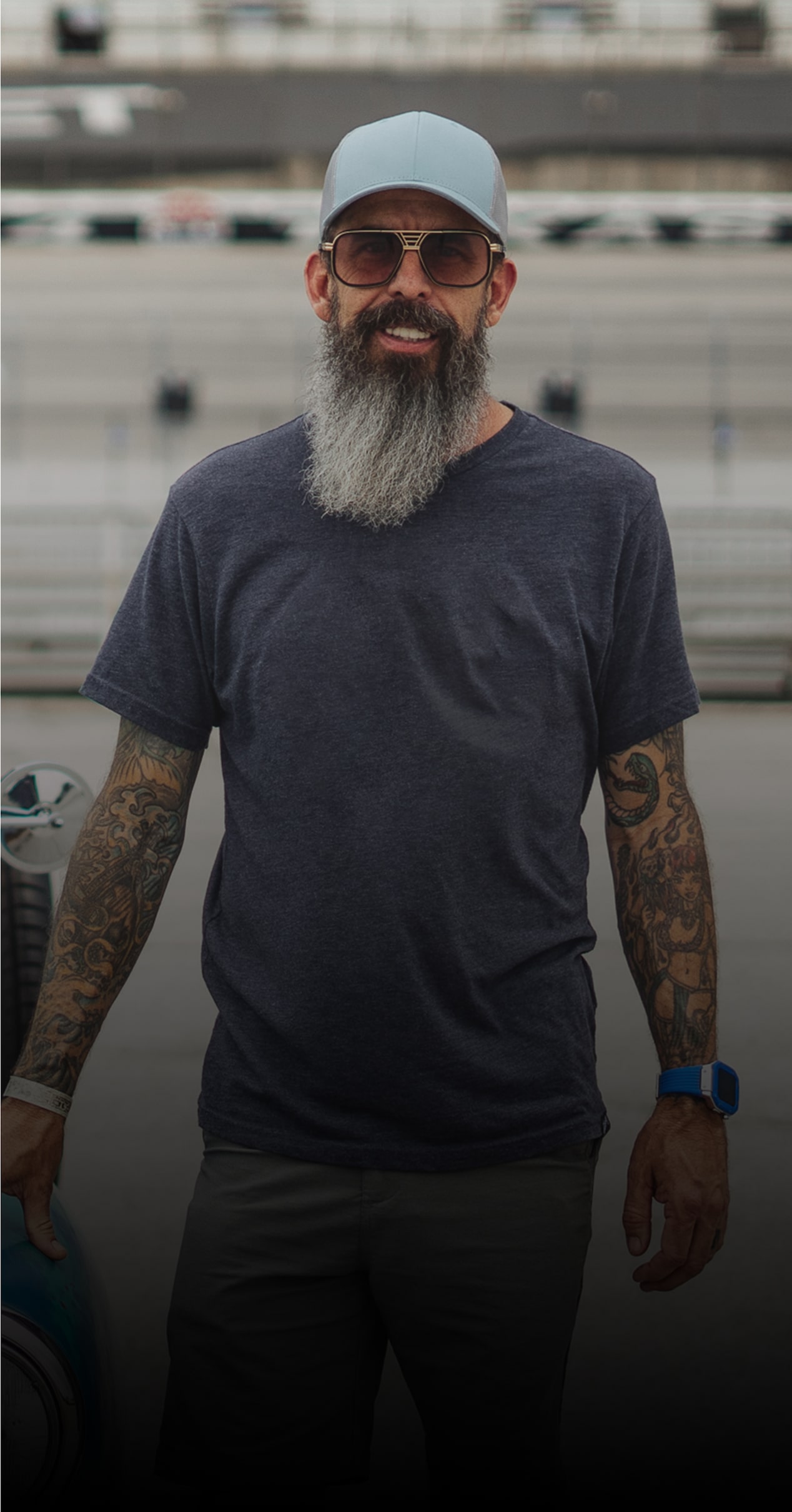 Shay Brummer at a Racetrack Next to a Vintage Blue Chevy Pickup Truck