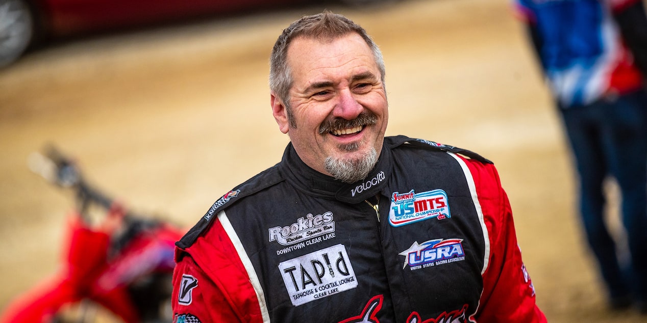 Race Car Driver Smiling in his Race Suit