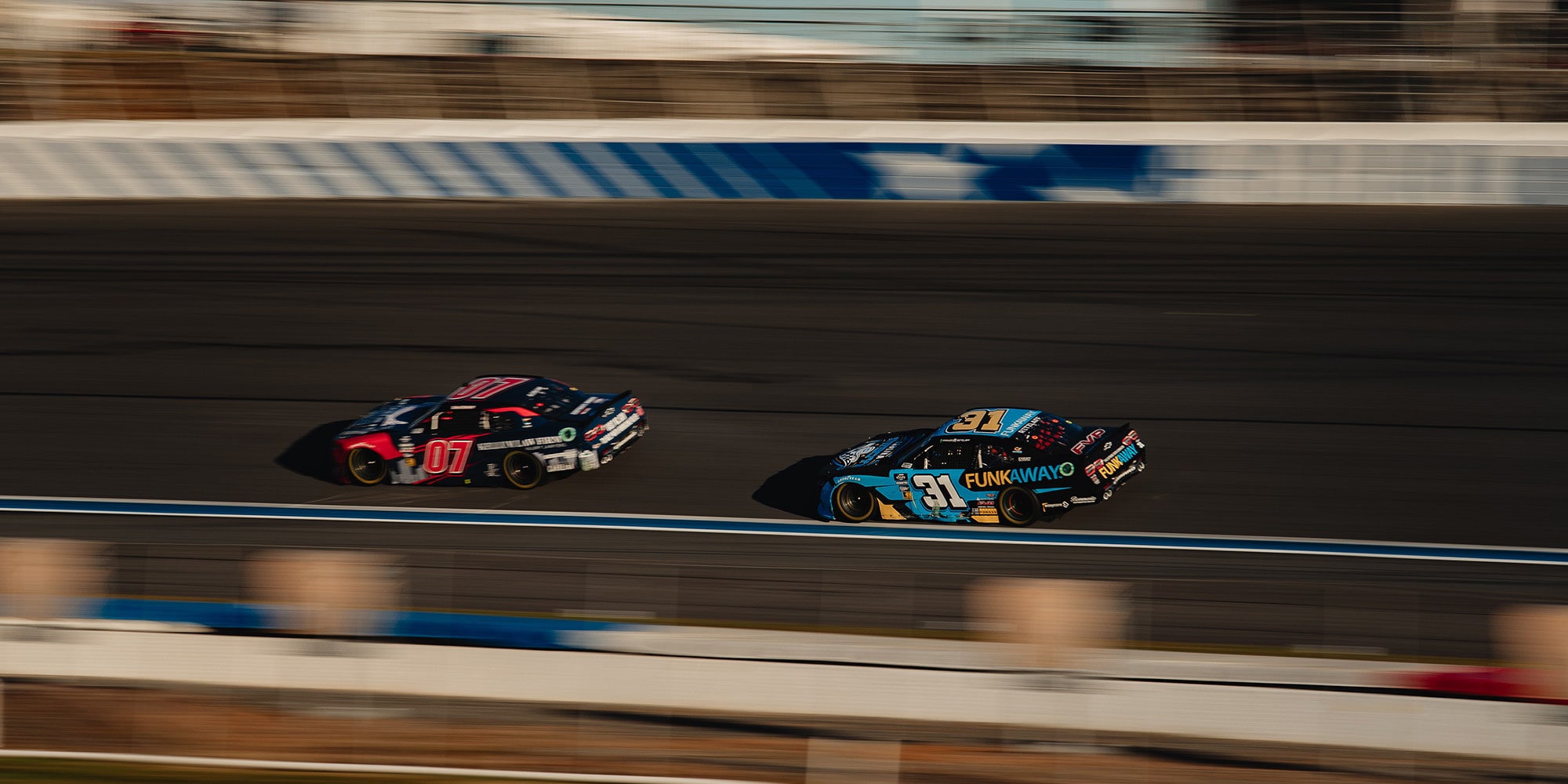 Two Camaro Race Cars on a Track