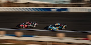 Two Camaro Race Cars on a Track