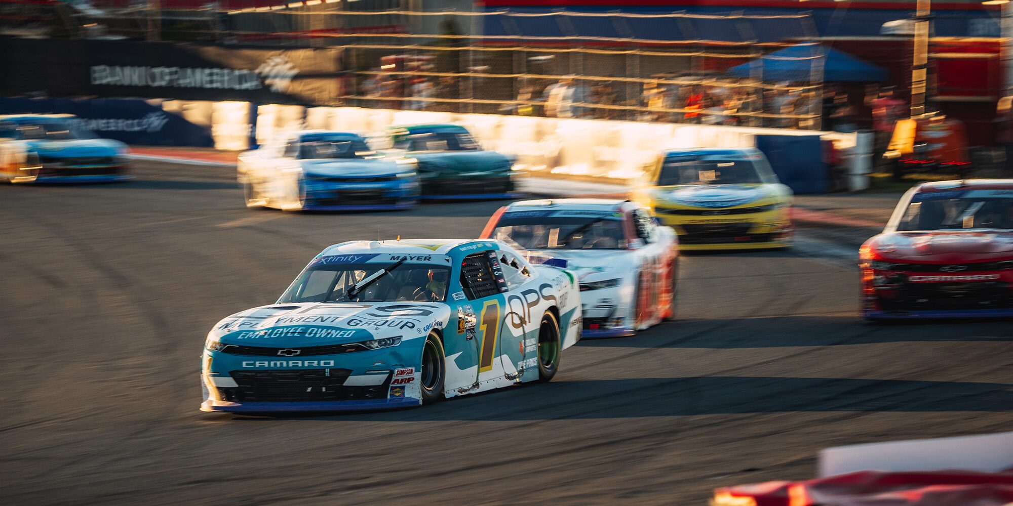 A Group of Race Cars Driving on a Track
