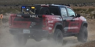Rear View of a Red Truck on a Dirt Road