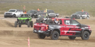 A Group of Off-Roading Trucks in the Desert