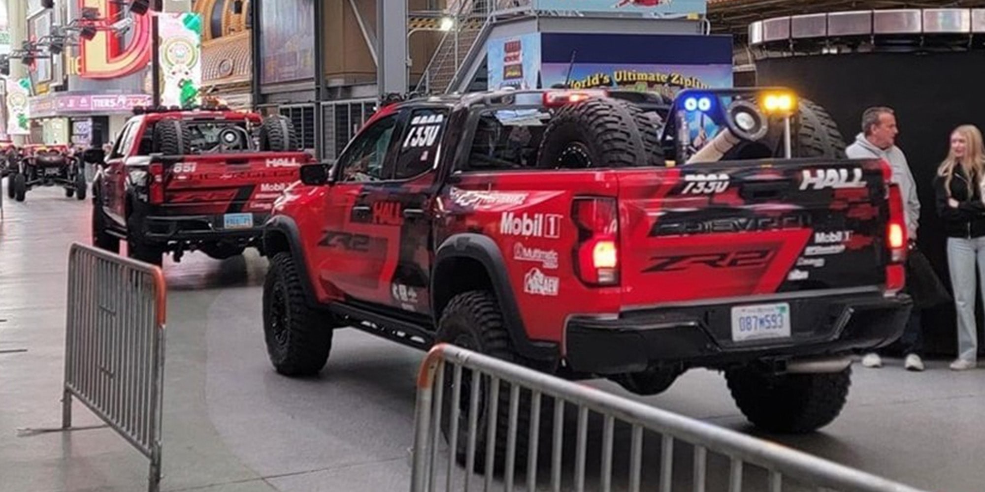 Off-Roading Trucks Lined Up Inside a Performance Hall