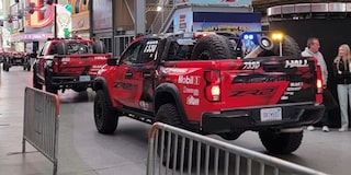 Off-Roading Trucks Lined Up Inside a Performance Hall