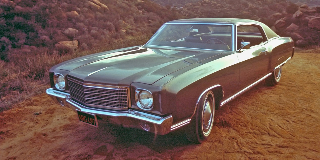 A 1970 Chevy Monte Carlo Parked in the Desert with Hills in the Distance