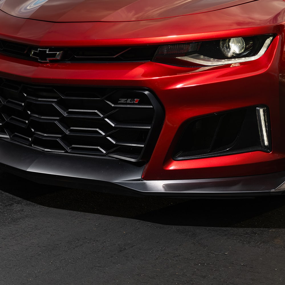 Close-up View Highlighting the Red Chevrolet Camaro Front End with the Headlight and Grille