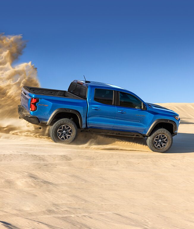 An off-roading Chevy pickup kicks up an impressive wake of dirt.