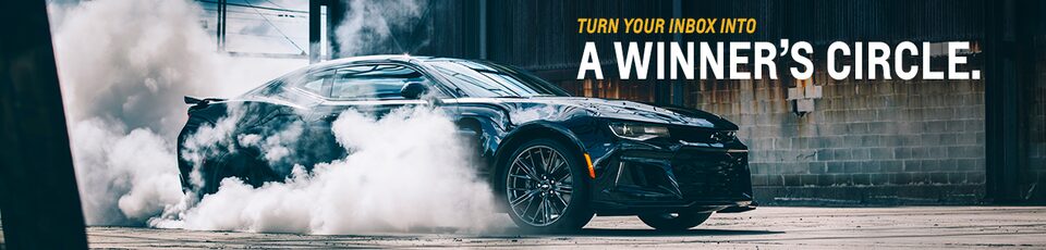 A Chevrolet Camaro Surrounded by Smoke with Text Overlay “Turn Your Inbox Into a Winner’s Circle”