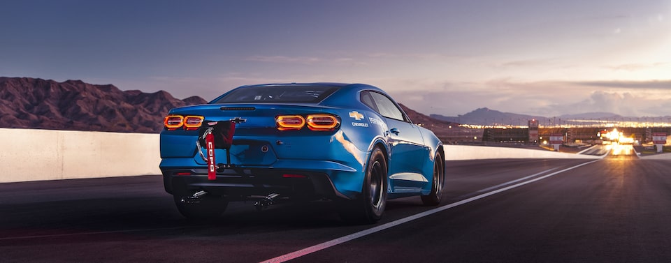 Blue Chevrolet eCOPO Camaro on Racetrack – Rear Side View