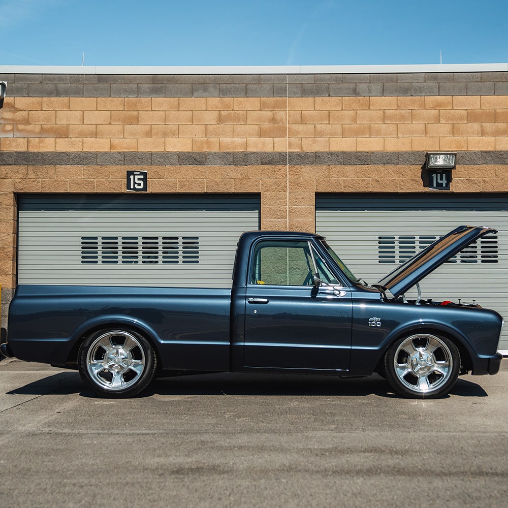 Classic pickup truck parked near garages
