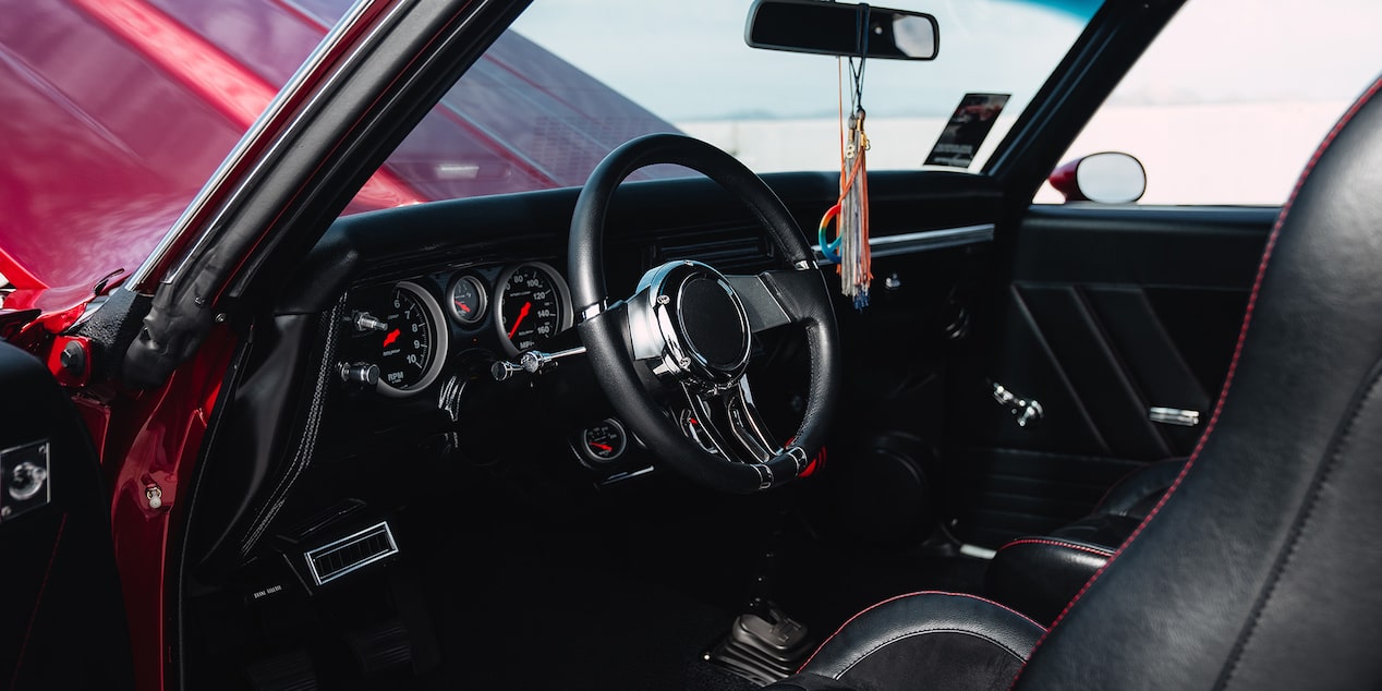 Driver's Side View of Vintage Chevy Vehicle with the Door Open and the Hood Open