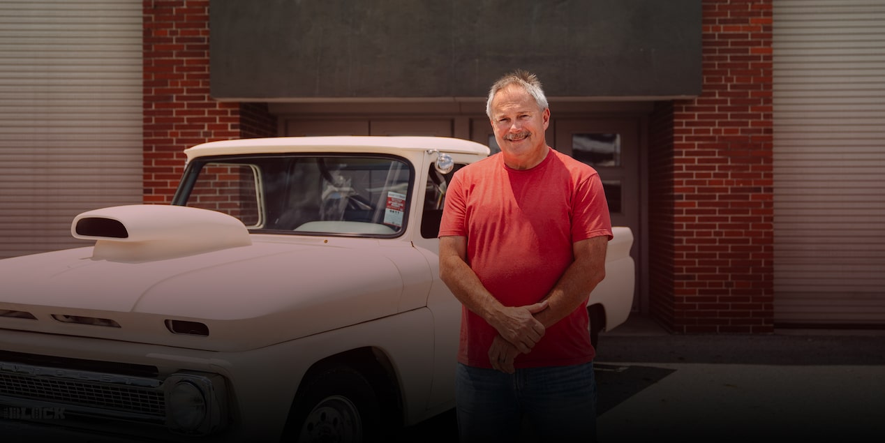 Noah Endicott Poses in Front of His Classic Tan Chevy Pickup Truck