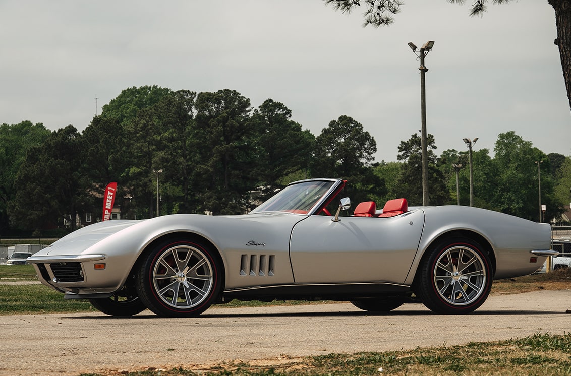 Left Side View of a Silver 1969 Chevy Corvette Convertible in a Parking Lot