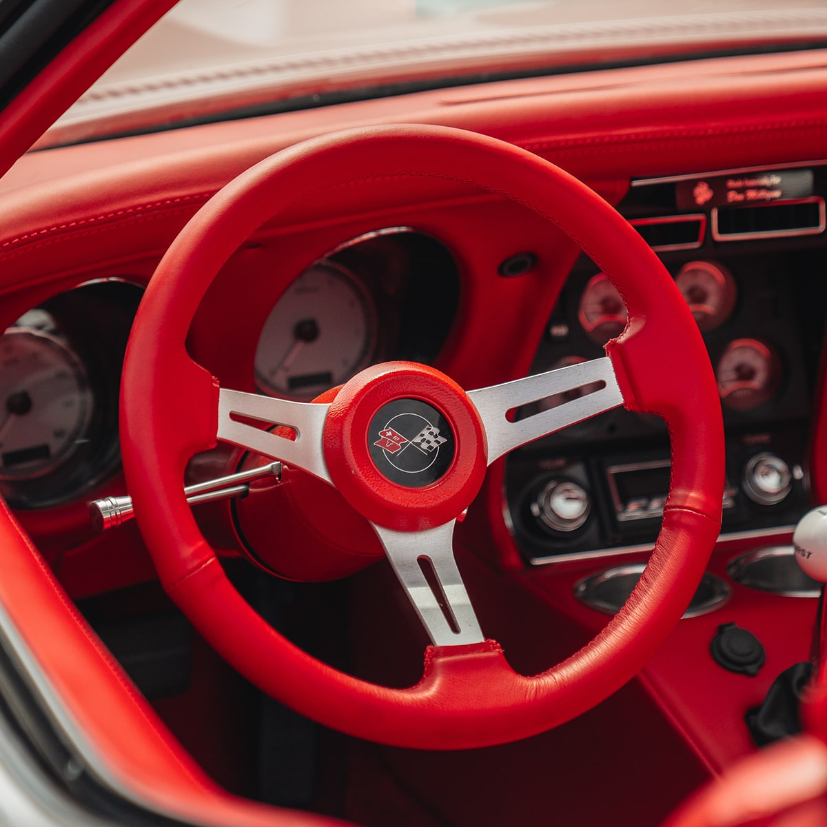 Close-Up of the Bright Red Steering Wheel and Interior of a 1969 Chevrolet Corvette
