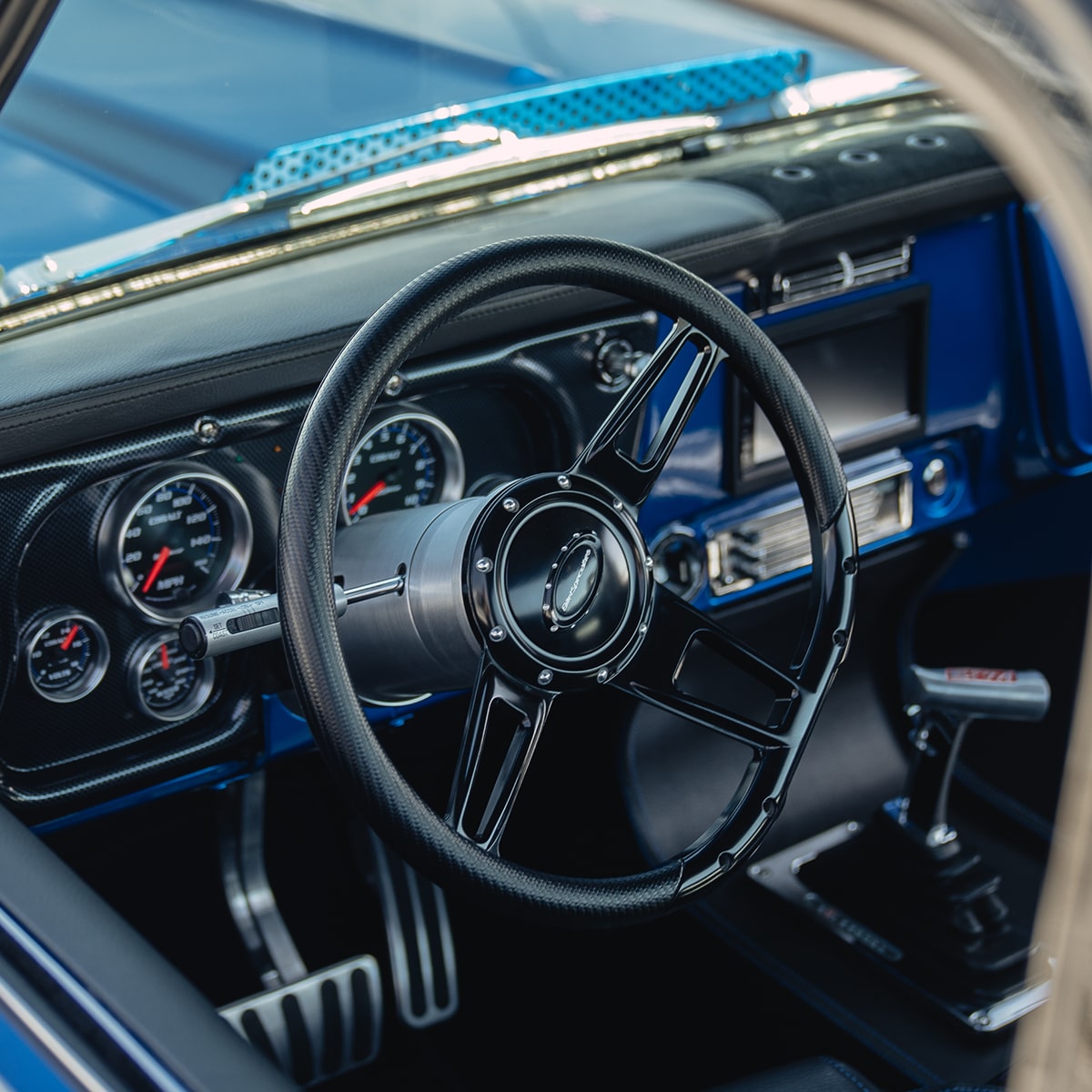 View of the Steering Wheel in a 1972 Chevy Bruzer Pickup Truck Seen Through the Driver's Side Window