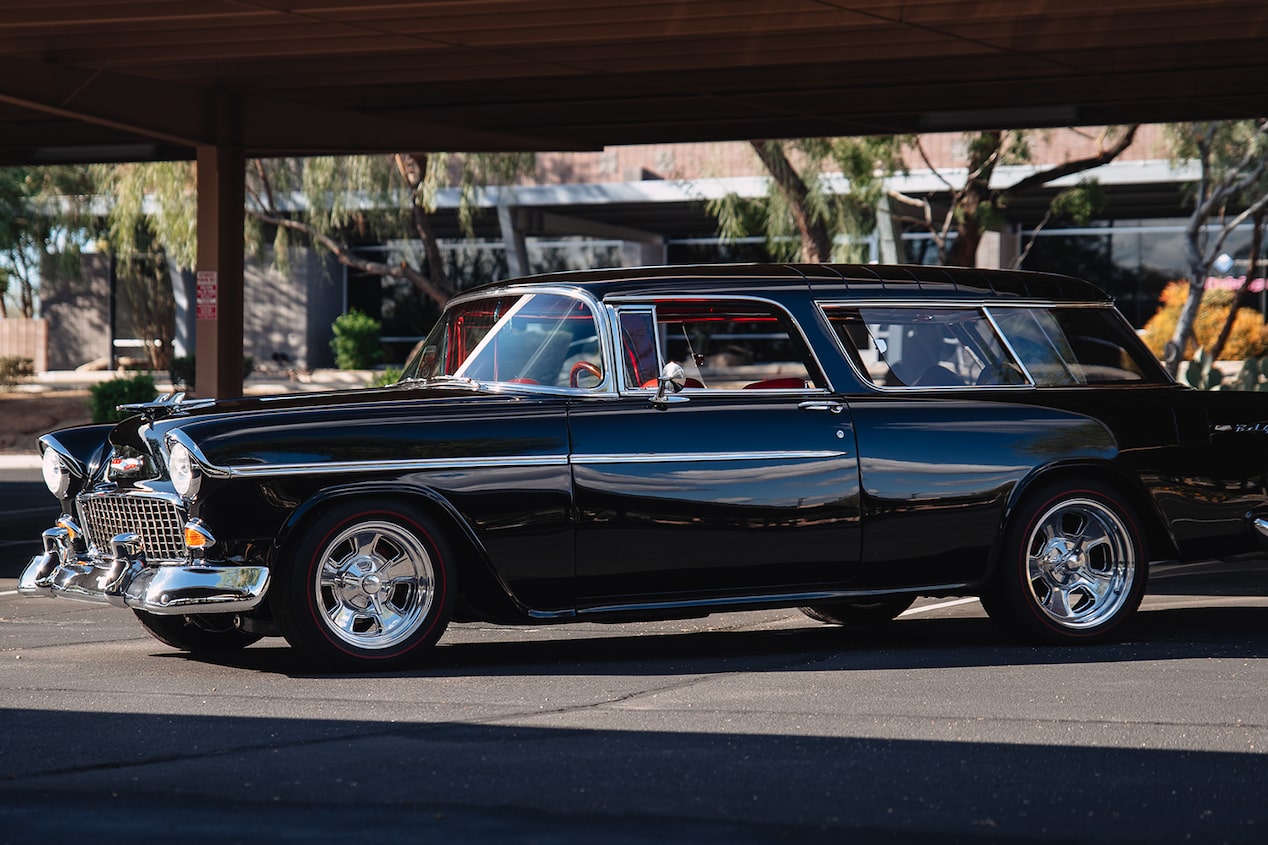 Side View of a Black 1955 Chevrolet Bel Air in a Parking Lot