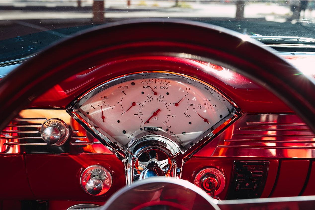 View from the Driver's Seat of the Top Half of the Steering Wheel in a 1955 Chevrolet Bel Air with Red Trim
