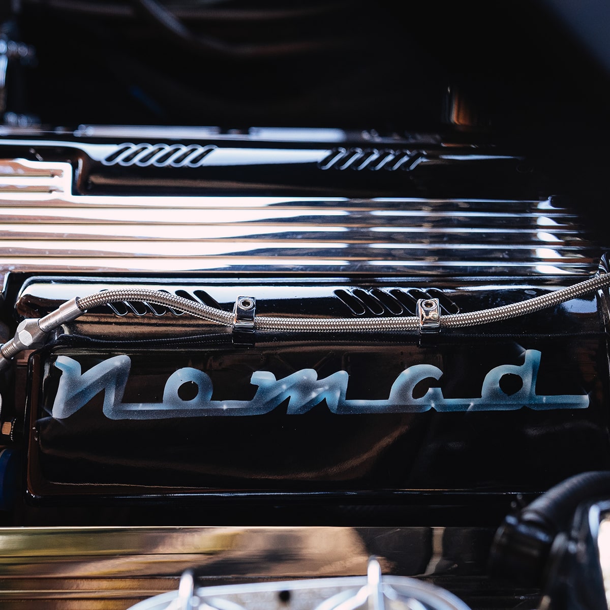 Close-up of the Chevy Performance Parts LT1 Crate Engine in a 1955 Chevrolet Nomad with "Nomad" Written on the Engine