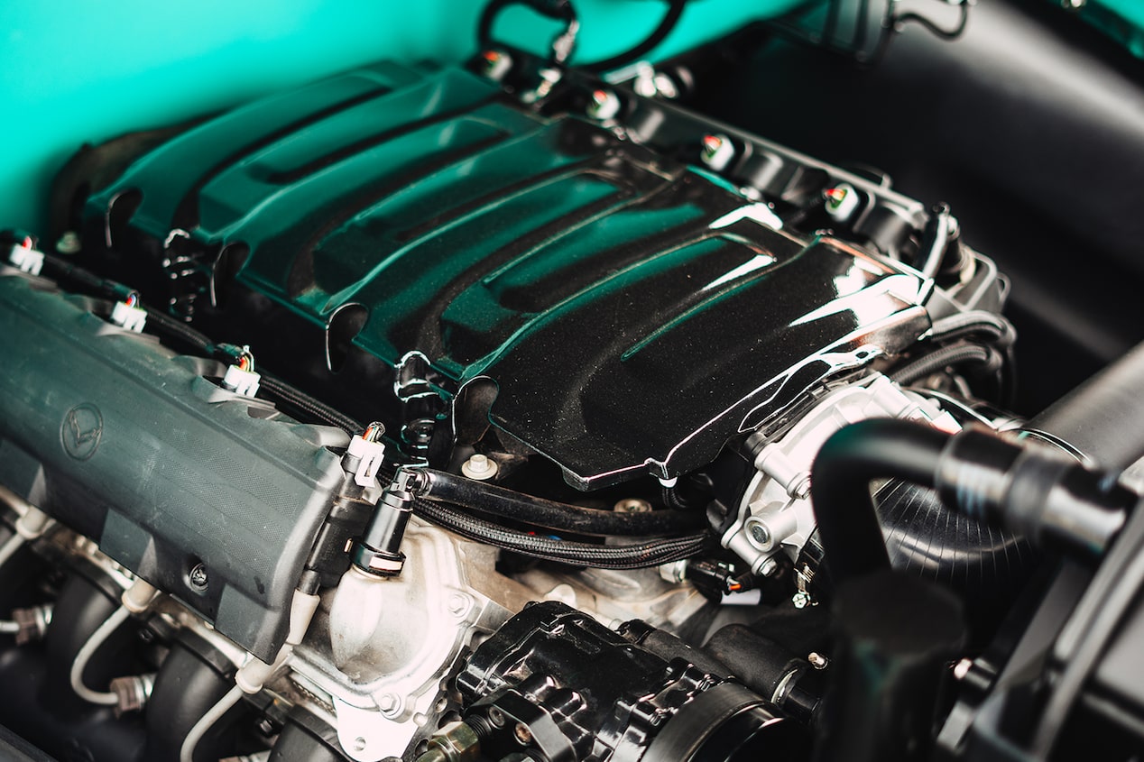 A Chevrolet Performance Parts LT1 Crate Engine Housed in the Engine Bay of a Blue 1955 Chevy Pickup Truck