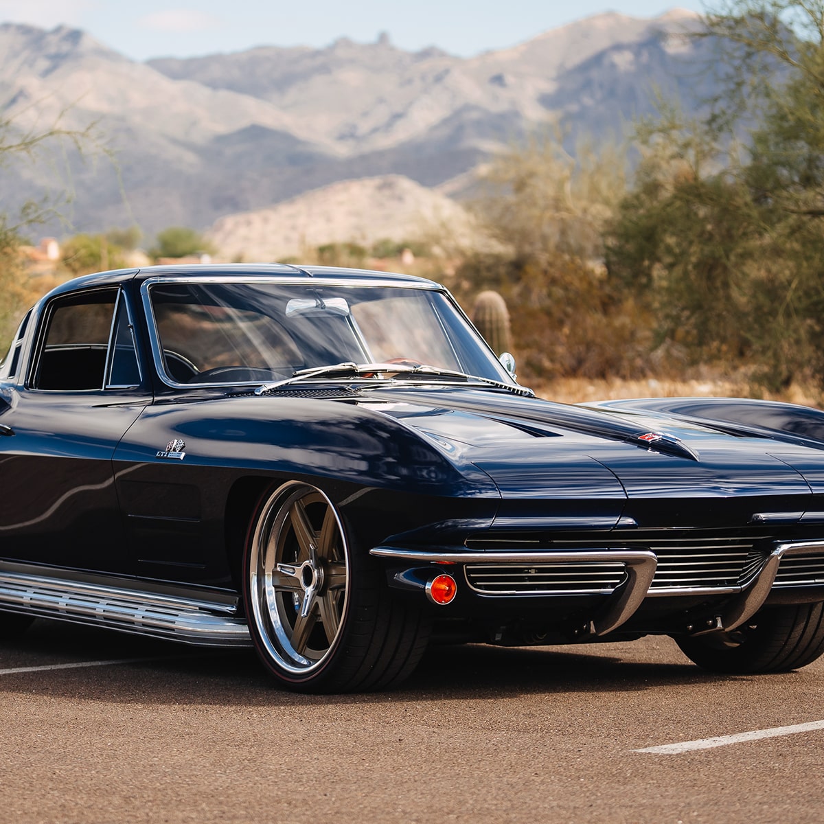Three Quarters View of a Black 1964 Chevrolet Corvette Stingray in a Parking Lot