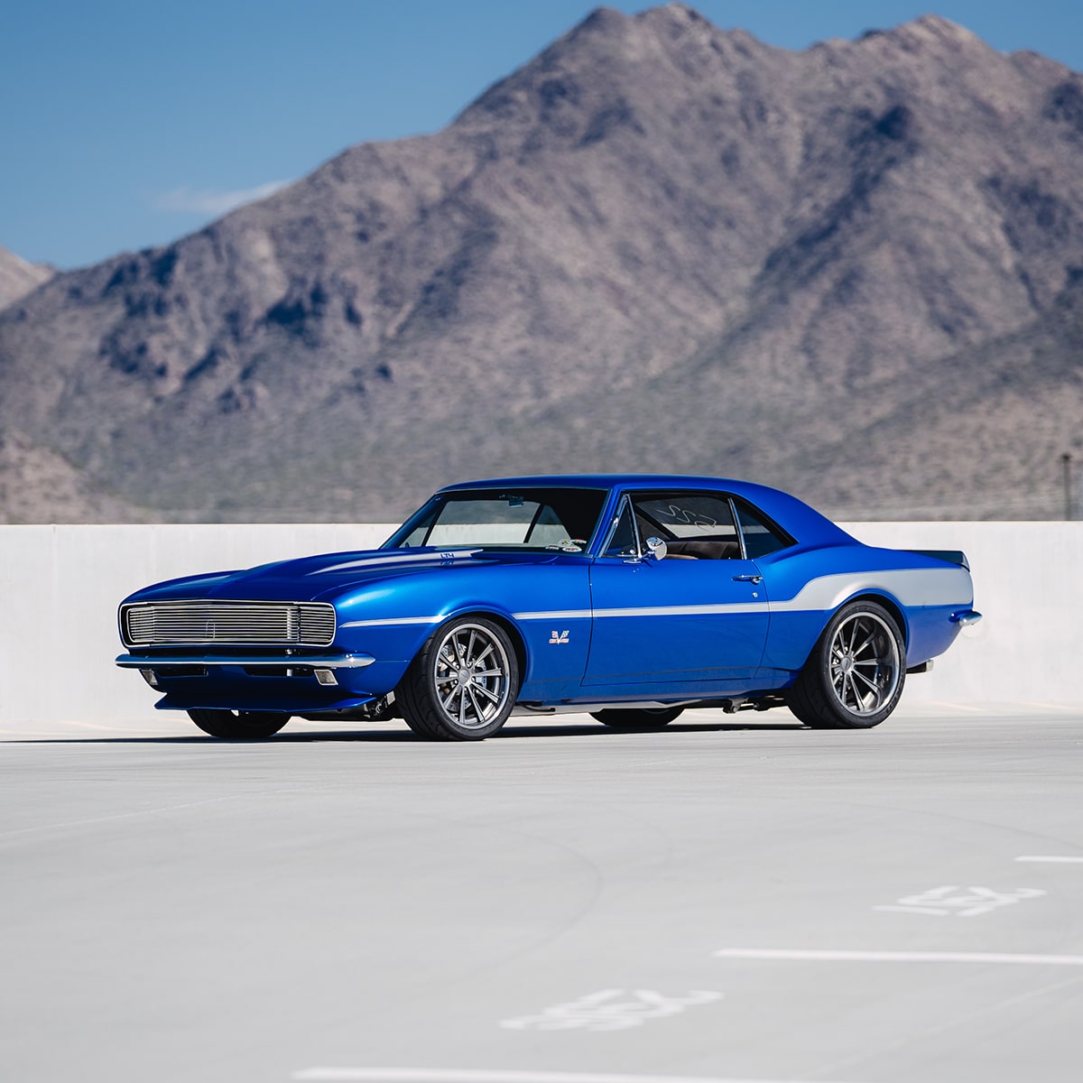 Side View of a Blue 1967 Chevy Camaro SS with Mountains in the Backgrouund