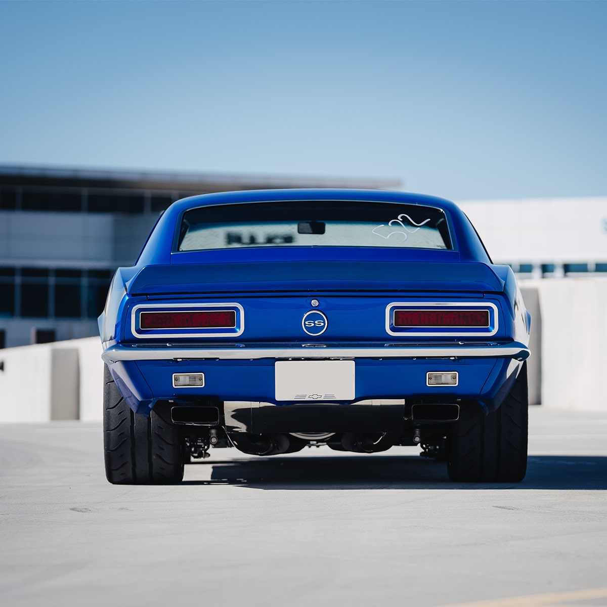 Rear View of a Blue 1967 Chevy Camaro SS in a Parking Lot