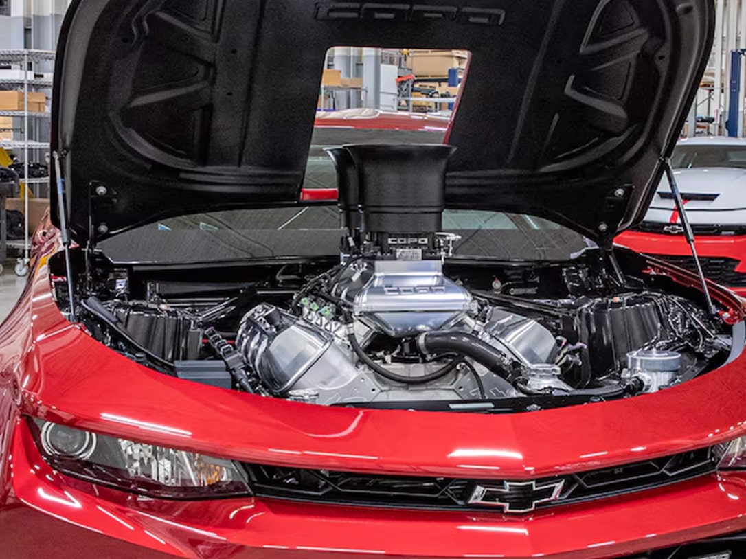 Front View of a Red Chevrolet Car with an Open Hood and a Visible LS3 Engine