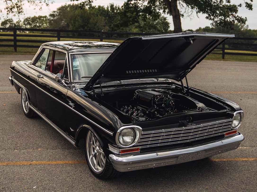 Front Three Quarters View of a Classic Black GM Car with the Hood Open and Engine Visible