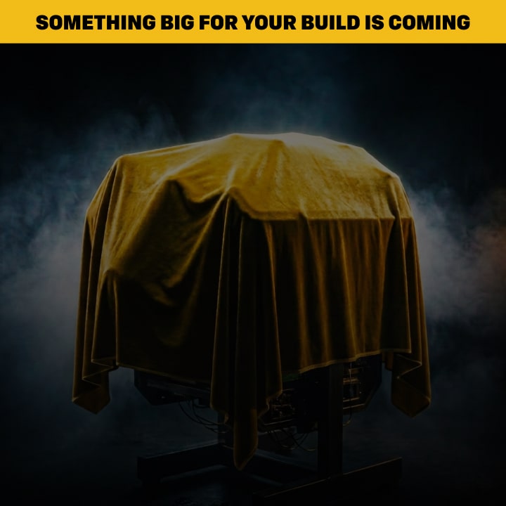 AEngine Block Covered In a Yellow Tarp In the Middle of A Smokey Room Within a Four by Three Frame