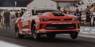 A COPO Camaro Racing on a Track with the Front Tires Up